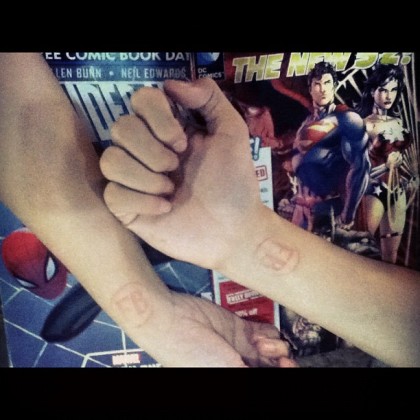 Our free comic books each and the FB stamps on our wrists at last year's Free Comic Book Day  of Fully Booked Bonifacio High Street
